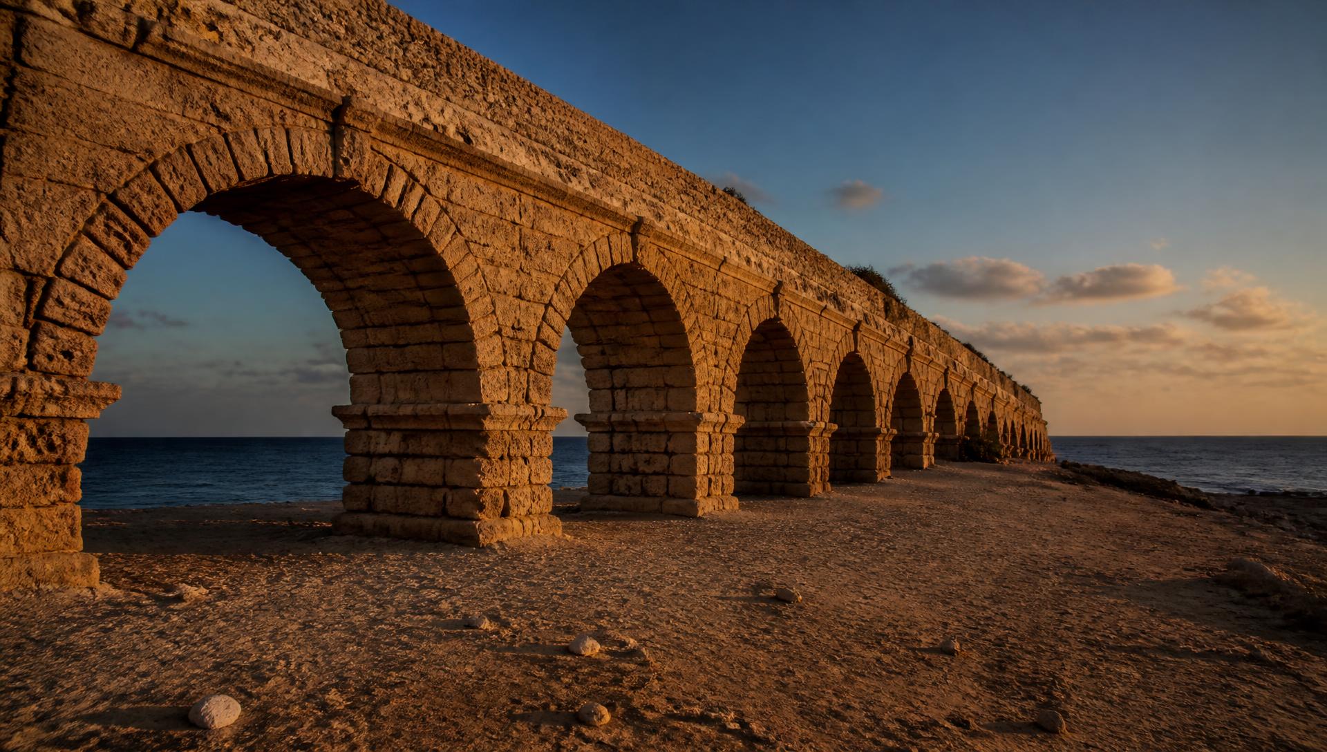 The ancient Roman aqueduct at Caesarea as it stands today, in low evening light.